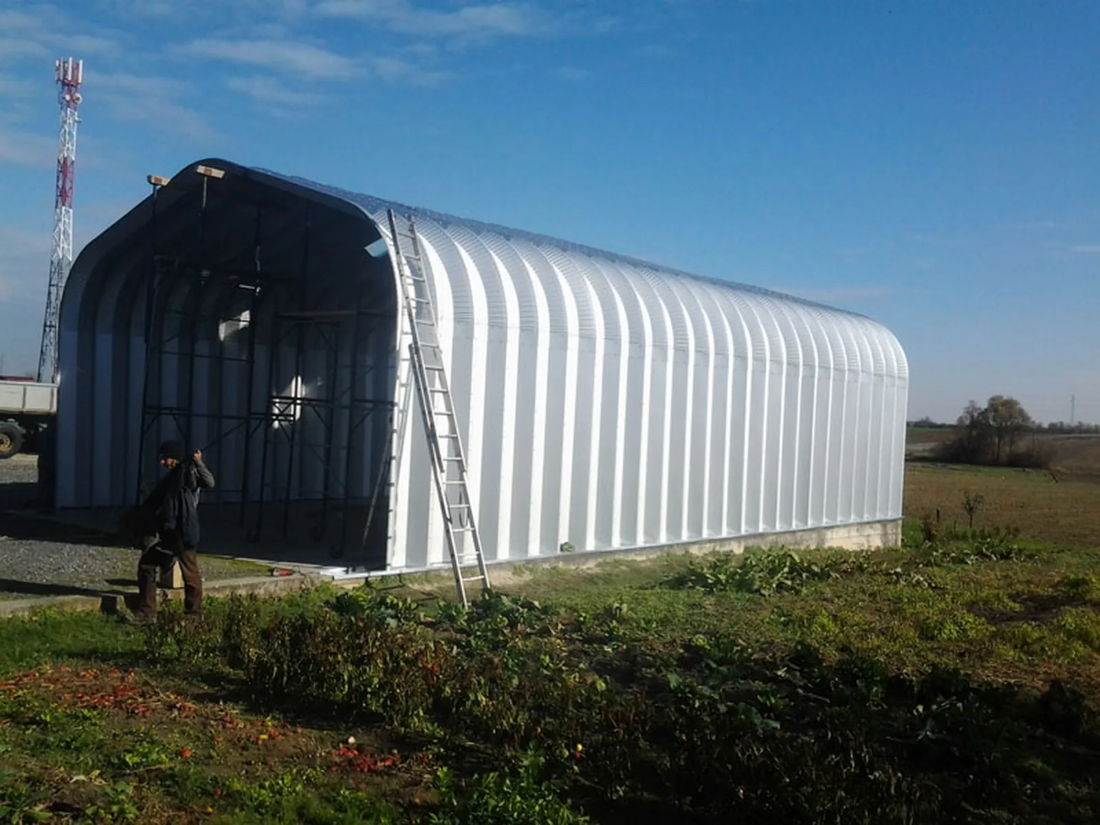 An arched steel hall in a field